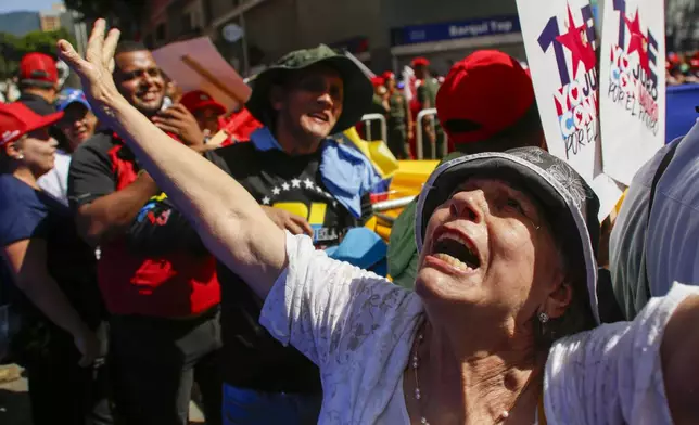 Government supporters gather outside the National Assembly during the swearing-in ceremony for Venezuelan President Nicolas Maduro for a third term in Caracas, Venezuela, Friday, Jan. 10, 2025. (AP Photo/Cristian Hernandez)