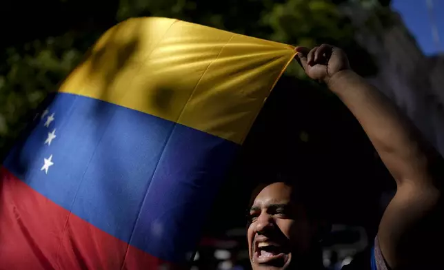 An opponent of Venezuelan President Nicolas Maduro protests the day before his inauguration for a third term, at Plaza de Mayo in Buenos Aires, Argentina, Thursday, Jan. 9, 2025. (AP Photo/Natacha Pisarenko)