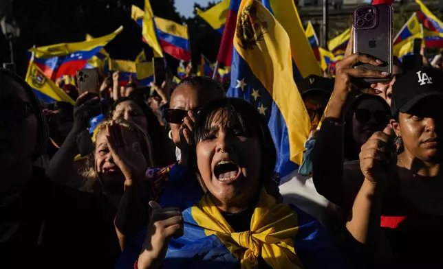 Opponents of Venezuelan President Nicolas Maduro participate in a protest the day before his inauguration for a third term, in Santiago, Chile, Thursday, Jan. 9, 2025. (AP Photo/Esteban Felix)