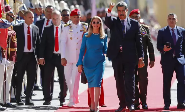 Venezuelan President Nicolas Maduro and his wife Cilia Flores arrive at the National Assembly for his swearing-in ceremony for a third term in Caracas, Venezuela, Friday, Jan. 10, 2025. (AP Photo/Cristian Hernandez)