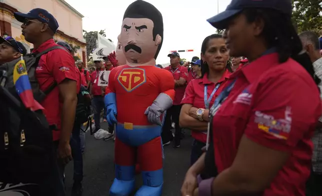 A government supporter dressed as Super Mustache, a character depicting President Nicolas Maduro as a superhero, stands outside of Miraflores Palace after a rally, days ahead of Maduro's presidential inauguration for a third term in Caracas, Venezuela, Wednesday, Jan 8, 2025. (AP Photo/Ariana Cubillos)