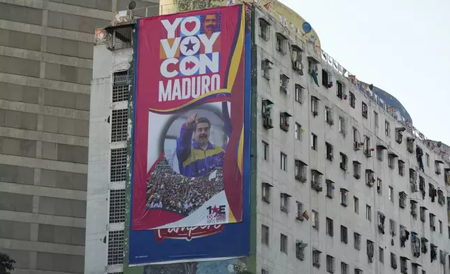 A campaign banner of President Nicolas Maduro adorns a building in Caracas, Venezuela, Wednesday, Jan 8, 2025. (AP Photo/Ariana Cubillos)