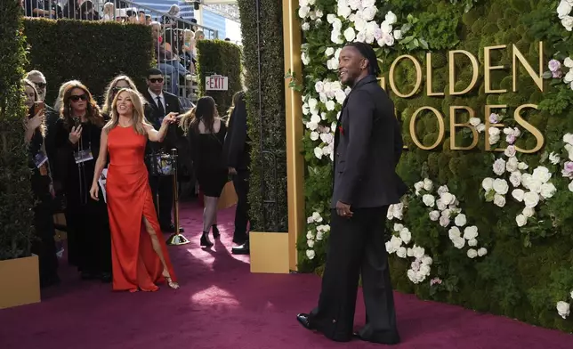 Kit Hoover, left, and Scott Evans arrive at the 82nd Golden Globes on Sunday, Jan. 5, 2025, at the Beverly Hilton in Beverly Hills, Calif. (Photo by Jordan Strauss/Invision/AP)