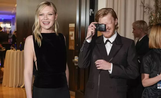 Kirsten Dunst, left, and Jesse Plemons arrive at the 82nd Golden Globes on Sunday, Jan. 5, 2025, at the Beverly Hilton in Beverly Hills, Calif. (AP Photo/Chris Pizzello)