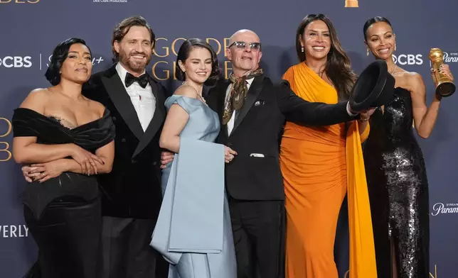 Adriana Paz, from left, Edgar Ramirez, Selena Gomez, Jacques Audiard, Karla Sofia Gascon, and Zoe Saldana pose in the press room with the award for best motion picture - musical or comedy for "Emilia Perez" during the 82nd Golden Globes on Sunday, Jan. 5, 2025, at the Beverly Hilton in Beverly Hills, Calif. (AP Photo/Chris Pizzello)