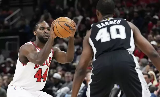 Chicago Bulls forward Patrick Williams, left, looks to shoot against San Antonio Spurs forward Harrison Barnes, right, during the first half of an NBA basketball game in Chicago, Monday, Jan. 6, 2025. (AP Photo/Nam Y. Huh)