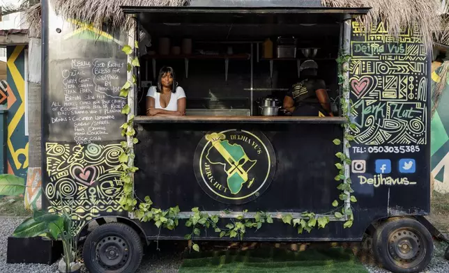 Deijha Gordon, 33, poses for a photograph in her food truck in Accra, Ghana, Wednesday, Dec. 11, 2024. Deijha, who relocated from New York, has obtained Ghanaian citizenship. (AP Photo/Misper Apawu)