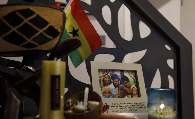 A family photo of Keachia Bowers, Damon Smith, and their children sits in their home in Accra, Ghana, Friday, Dec. 6, 2024. The family relocated to Ghana from Florida and has obtained Ghanaian citizenship. (AP Photo/Misper Apawu)