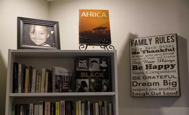 African books sit on the bookshelf at the Keachia Bowers and Damon Smith's family home in Accra, Ghana, Friday, Dec. 6, 2024. The family of four relocated to Ghana from Florida and have obtained Ghanaian citizenship. (AP Photo/Misper Apawu)