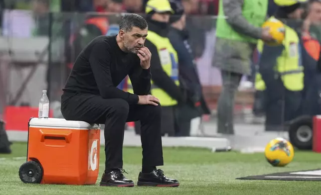 AC Milan's head coach Sergio Conceicao watches from the sideline during the Serie A soccer match between AC Milan and Cagliari at the San Siro stadium, in Milan, Italy, Saturday, Jan. 11, 2025. (AP Photo/Antonio Calanni)