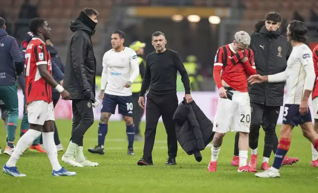 AC Milan's head coach Sergio Conceicao, center, leaves the pitch after the Serie A soccer match between AC Milan and Cagliari at the San Siro stadium, in Milan, Italy, Saturday, Jan. 11, 2025. (AP Photo/Antonio Calanni)