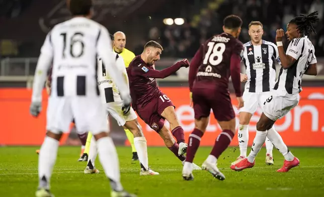 Torino's Nikola Vlasic strikes to score during the Italian Serie A soccer match between Torino FC and Juventus, at the Stadio Olimpico Grande Torino, in Turin, Italy, Saturday, Jan. 11, 2025. (Fabio Ferrari/Lapresse via AP)