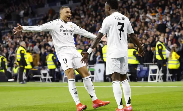 Real Madrid's Vinicius Junior, right, celebrates with Kylian Mbappe after scoring his side's 2nd goal against Celta de Vigo during a Copa del Rey round of 16 soccer match at the Santiago Bernabeu stadium in Madrid, Spain, Thursday, Jan. 16, 2025. (AP Photo/Pablo Garcia)
