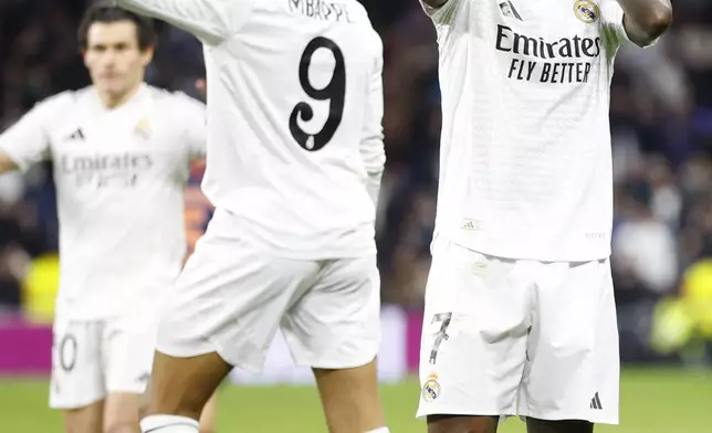 Real Madrid's Vinicius Junior, right, celebrates after scoring his side's 2nd goal against Celta de Vigo during a Copa del Rey round of 16 soccer match at the Santiago Bernabeu stadium in Madrid, Spain, Thursday, Jan. 16, 2025. (AP Photo/Pablo Garcia)