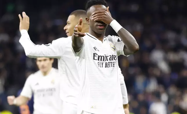 Real Madrid's Vinicius Junior, right, celebrates after scoring his side's 2nd goal against Celta de Vigo during a Copa del Rey round of 16 soccer match at the Santiago Bernabeu stadium in Madrid, Spain, Thursday, Jan. 16, 2025. (AP Photo/Pablo Garcia)
