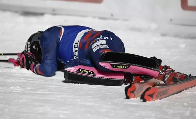 Croatia's Zrinka Ljutic lies in the snow after winning a women's World Cup slalom, in Courchevel, France, Thursday Jan. 30, 2025. (AP Photo/Gabriele Facciotti)