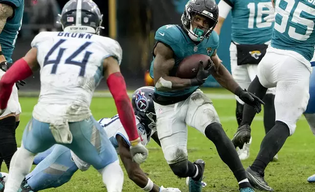 Jacksonville Jaguars running back Tank Bigsby (4) runs the ball against the Tennessee Titans during the second half of an NFL football game, Sunday, Dec. 29, 2024, in Jacksonville, Fla. (AP Photo/John Raoux)