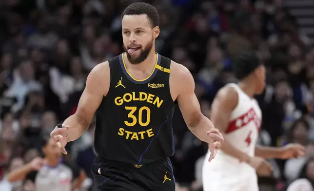Golden State Warriors guard Stephen Curry (30) reacts after scoring during second-half NBA basketball game action against the Toronto Raptors in Toronto, Monday, Jan. 13, 2025. (Nathan Denette/The Canadian Press via AP)