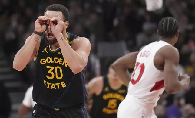 Golden State Warriors guard Stephen Curry (30) reacts after scoring during second-half NBA basketball game action against the Toronto Raptors in Toronto, Monday, Jan. 13, 2025. (Nathan Denette/The Canadian Press via AP)