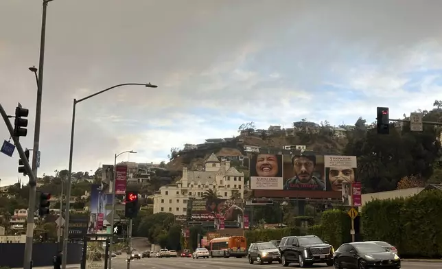 Smoke fills the sky from the Palisades Fire above the Chateau Marmont hotel near the intersection of Sunset Blvd. and Crescent Heights Blvd. Wednesday morning, Jan. 8, 2024, in Los Angeles. (AP Photo/Michael Blood)