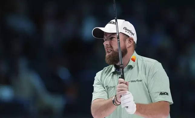 Shane Lowry of The Bay Golf Club watches a shot on the tenth hole, during the inaugural match of the TMRW Golf League, against New York Golf Club, Tuesday, Jan. 7, 2025, in Palm Beach Gardens, Fla. TGL features six teams of four players competing against each other in a tech-infused arena the size of a football field. (AP Photo/Rebecca Blackwell)