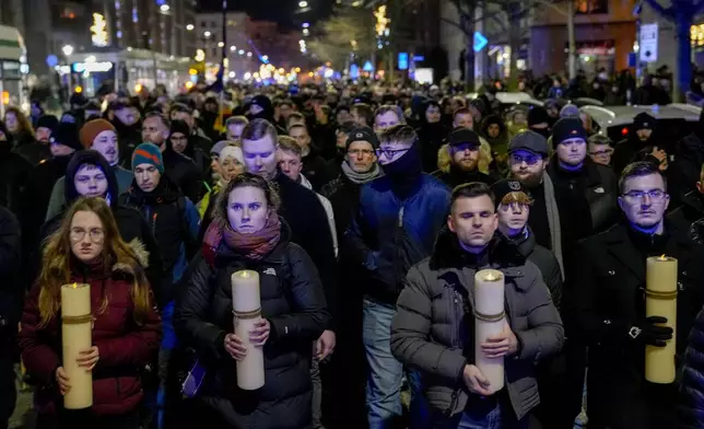 FILE - People carry candles attending an AfD election campaign in front of the cathedral in Magdeburg, Germany, on Dec. 23, 2024. (AP Photo/Ebrahim Noroozi, File)