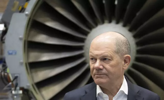 German Chancellor Olaf Scholz speaks during a visit to the company MTU Maintenance Berlin-Brandenburg in his constituency, Ludwigsfelde, Germany, Tuesday, Jan. 7, 2025. (Christoph Gollnow/dpa via AP)