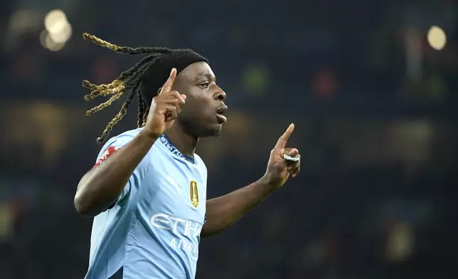 Manchester City's Jeremy Doku celebrates after scoring during the English FA Cup soccer match between Manchester City and Salford City at Etihad Stadium in Manchester, Saturday, Jan. 11, 2025. (AP Photo/ Dave Thompson)