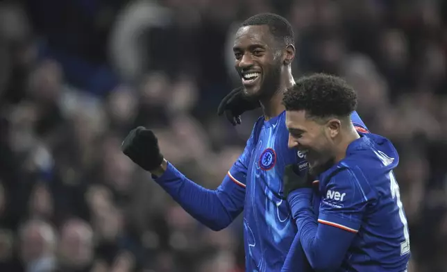 Chelsea's Tosin Adarabioyo celebrates with Chelsea's Jadon Sancho after scoring his side's third goal during the English FA Cup soccer match between Chelsea and Morecambe at Stamford Bridge stadium in London, Saturday, Jan. 11, 2025. (AP Photo/ Kin Cheung)