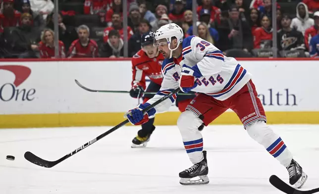 New York Rangers center Sam Carrick (39) scores a goal during the second period of an NHL hockey game against the Washington Capitals, Saturday, Jan. 4, 2025, in Washington. (AP Photo/John McDonnell)