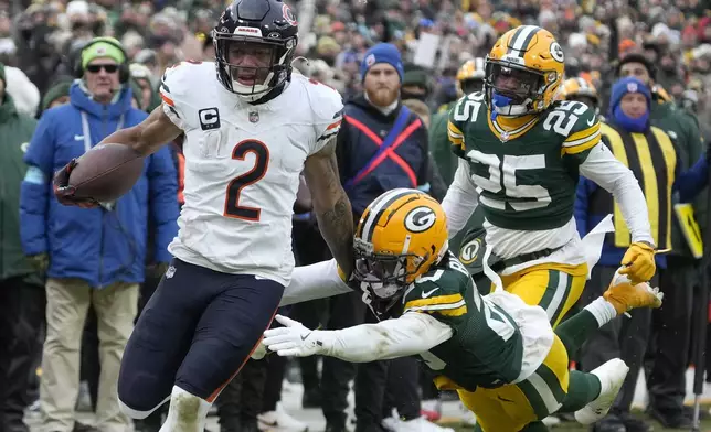 Chicago Bears wide receiver DJ Moore (2) runs past Green Bay Packers safety Javon Bullard, middle, and cornerback Keisean Nixon (25) to score during the second half of an NFL football game, Sunday, Jan. 5, 2025, in Green Bay, Wis. (AP Photo/Morry Gash)