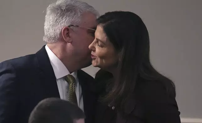 Republican Kelly Ayotte, a former U.S. senator who succeeds fellow Republican Chris Sununu, embraces her husband Joseph Daley during her inauguration at the State House, Thursday, Jan. 9, 2025, in Concord, N.H. (AP Photo/Charles Krupa)