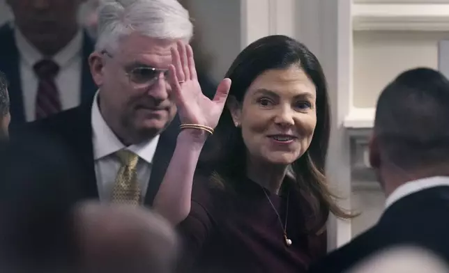 Republican Kelly Ayotte, a former U.S. senator who succeeds fellow Republican Chris Sununu, waves while arriving with her husband Joseph Daley during her inauguration at the State House, Thursday, Jan. 9, 2025, in Concord, N.H. (AP Photo/Charles Krupa)