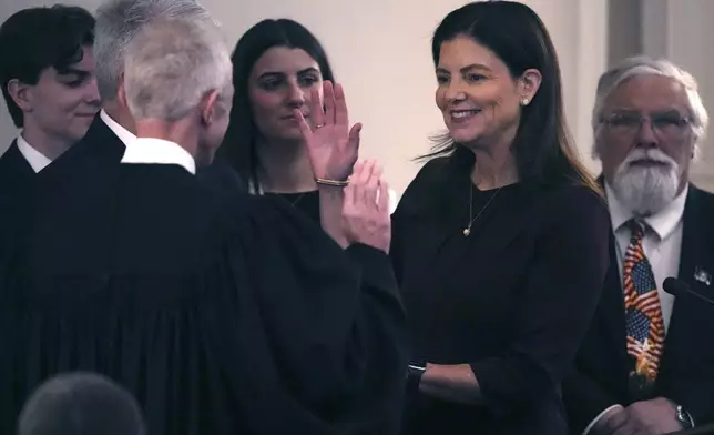 Republican Kelly Ayotte, a former U.S. senator who succeeds fellow Republican Chris Sununu, in sworn in during her inauguration at the State House, Thursday, Jan. 9, 2025, in Concord, N.H. (AP Photo/Charles Krupa)