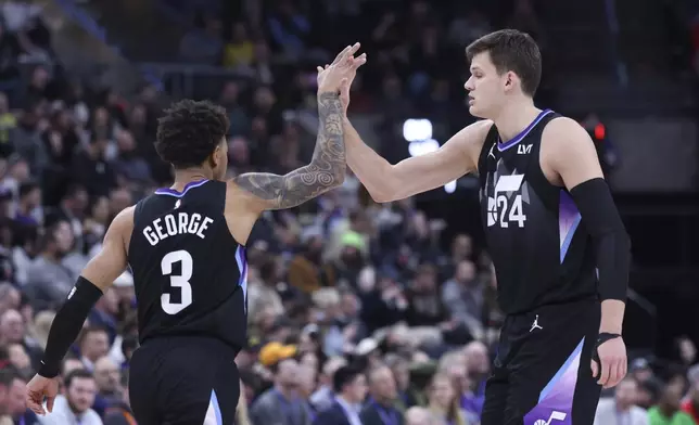 Utah Jazz guard Keyonte George (3) and center Walker Kessler (24) react to a play against the Charlotte Hornets during the second quarter of an NBA basketball game, Wednesday, Jan. 15, 2025, in Salt Lake City. (AP Photo/Rob Gray)