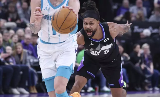 Charlotte Hornets guard LaMelo Ball dribbles past Utah Jazz guard Patty Mills (8) during the second quarter of an NBA basketball game, Wednesday, Jan. 15, 2025, in Salt Lake City. (AP Photo/Rob Gray)
