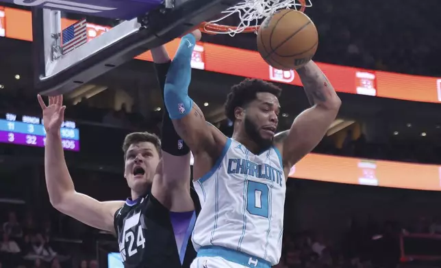 Charlotte Hornets forward Miles Bridges (0) dunks the ball against Utah Jazz center Walker Kessler (24) during the second quarter of an NBA basketball game, Wednesday, Jan. 15, 2025, in Salt Lake City. (AP Photo/Rob Gray)
