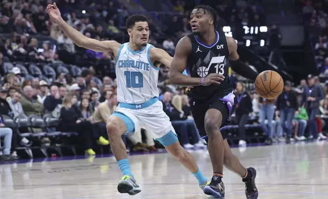 Utah Jazz guard Isaiah Collier (13) dribbles against Charlotte Hornets guard Josh Green (10) during the second half of an NBA basketball game, Wednesday, Jan. 15, 2025, in Salt Lake City. (AP Photo/Rob Gray)