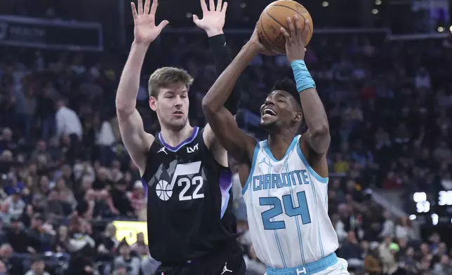 Charlotte Hornets forward Brandon Miller (24) goes to the basket against Utah Jazz forward Kyle Filipowski (22) during the second quarter of an NBA basketball game, Wednesday, Jan. 15, 2025, in Salt Lake City. (AP Photo/Rob Gray)