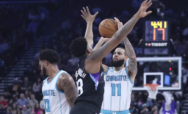 Charlotte Hornets forward Cody Martin (11) uses a screen by forward Miles Bridges (0) to shoot over Utah Jazz forward Brice Sensabaugh (28) during the second quarter of an NBA basketball game, Wednesday, Jan. 15, 2025, in Salt Lake City. (AP Photo/Rob Gray)