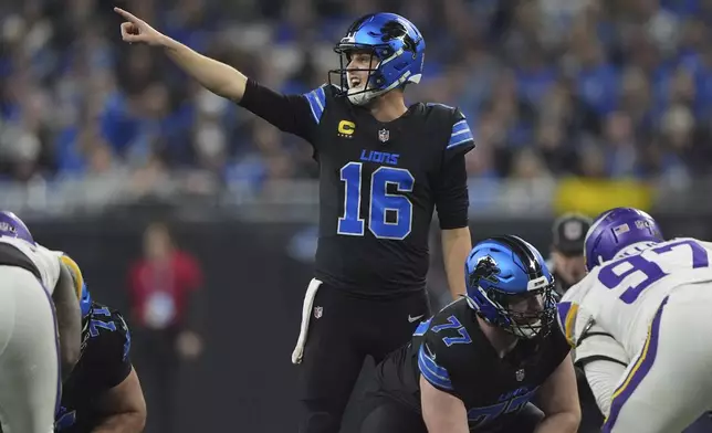 Detroit Lions quarterback Jared Goff (16) signals during the first half of an NFL football game against the Minnesota Vikings, Sunday, Jan. 5, 2025, in Detroit. (AP Photo/Charlie Riedel)