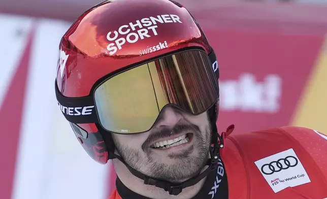 Switzerland's Loic Meillard smiles after an alpine ski, men's World Cup giant slalom race, in Adelboden, Switzerland, Sunday, Jan. 12, 2025. (AP Photo/Giovanni Zenoni)