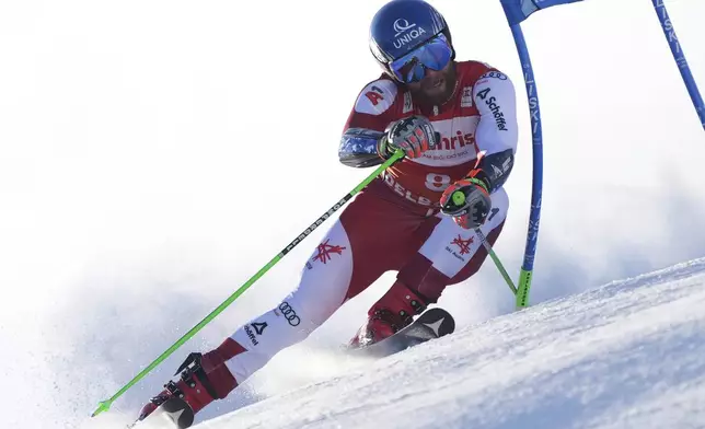 Austria's Marco Schwarz speeds down the course during an alpine ski, men's World Cup giant slalom race, in Adelboden, Switzerland, Sunday, Jan. 12, 2025. (AP Photo/Giovanni Zenoni)