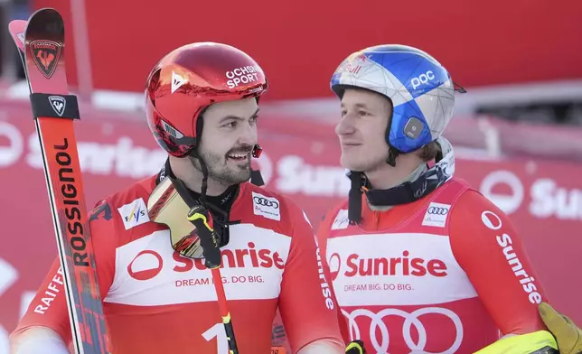 From left, second placed Switzerland's Loic Meillard and the winner Switzerland's Marco Odermatt after an alpine ski, men's World Cup giant slalom race, in Adelboden, Switzerland, Sunday, Jan. 12, 2025. (AP Photo/Giovanni Zenoni)