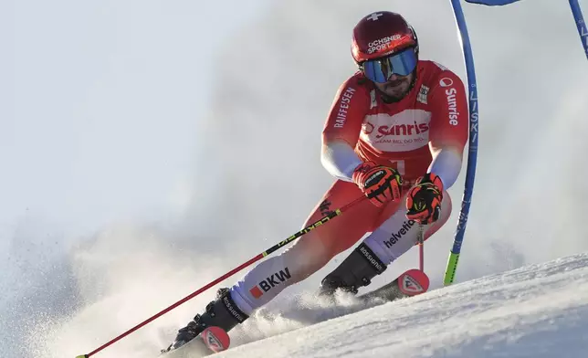 Switzerland's Loic Meillard speeds down the course during an alpine ski, men's World Cup giant slalom race, in Adelboden, Switzerland, Sunday, Jan. 12, 2025. (AP Photo/Giovanni Zenoni)