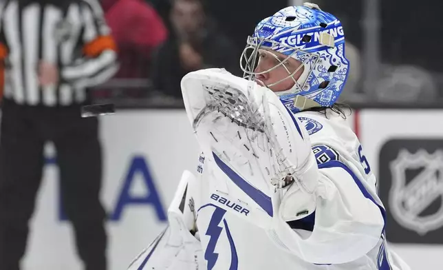 Tampa Bay Lightning goaltender Andrei Vasilevskiy makes a glove safe during the second period of an NHL hockey game against the Los Angeles Kings, Saturday, Jan. 4, 2025, in Los Angeles. (AP Photo/Mark J. Terrill)