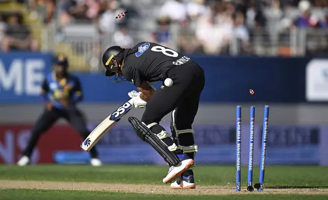 New Zealand's Rachin Ravindra is bowled by Sri Lanka's Asitha Fernando during the 3rd one day international cricket match at Eden Park in Auckland, New Zealand, Saturday, Jan. 11, 2025. (Andrew Cornaga/Photosport via AP)