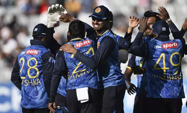 Sri Lanka players celebrate another wicket during the 3rd one day international cricket match against New Zealand at Eden Park in Auckland, New Zealand, Saturday, Jan. 11, 2025. (Andrew Cornaga/Photosport via AP)