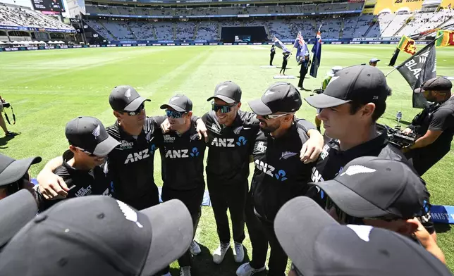 New Zealand captain Mitchell Santner talks to his team in a huddle during the 3rd one day international cricket match between New Zealand and Sri Lanka at Eden Park in Auckland, New Zealand, Saturday, Jan. 11, 2025. (Andrew Cornaga/Photosport via AP)