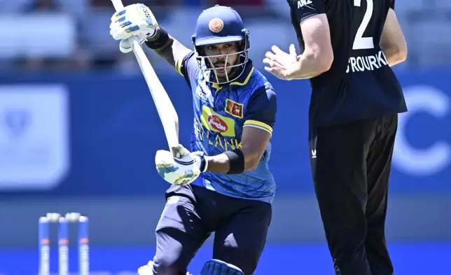 Sri Lanka's Pathum Nissanka runs around New Zealand's Will O'Rourke during the 3rd one day international cricket match between New Zealand and Sri Lanka at Eden Park in Auckland, New Zealand, Saturday, Jan. 11, 2025. (Andrew Cornaga/Photosport via AP)